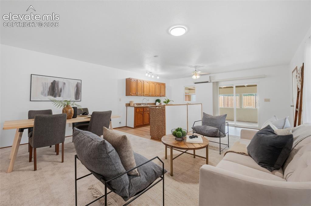Image 26 of 38: Spacious dining area featuring wood-finish flooring, a ceiling fan, and tra