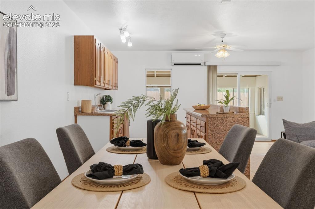 Image 27 of 38: Open-concept kitchen featuring wood cabinetry, granite-style countertops, d