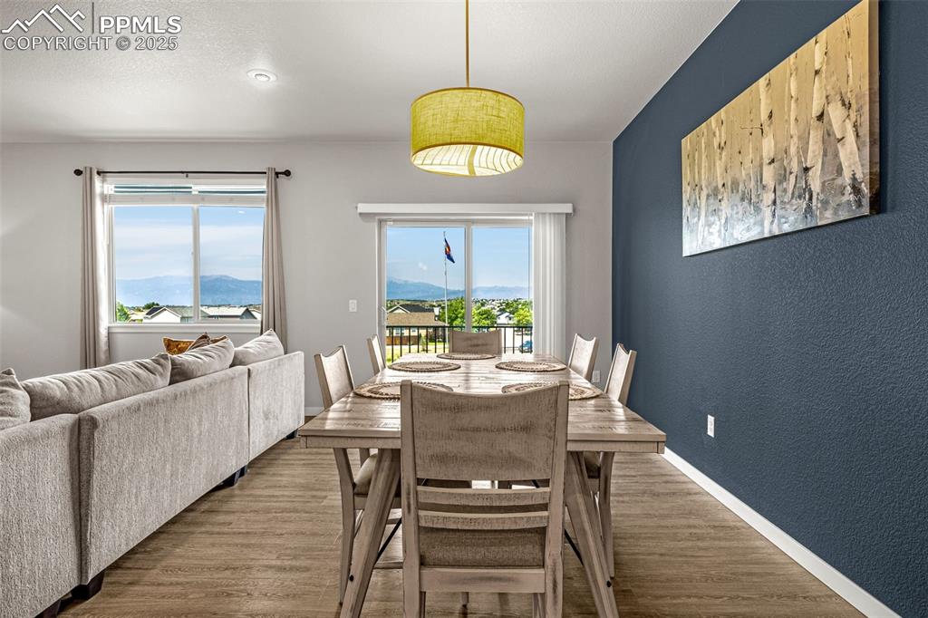 Image 10 of 33: Dining space featuring a mountain view, plenty of natural light, a textured
