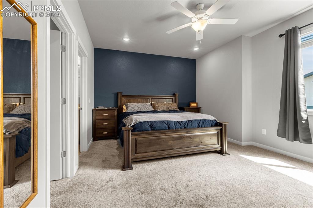 Image 14 of 33: Primary Bedroom with attached bathroom and walk-in closet