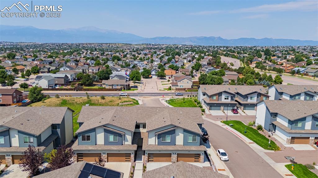 Image 2 of 33: Aerial view of residential area featuring a mountain backdrop