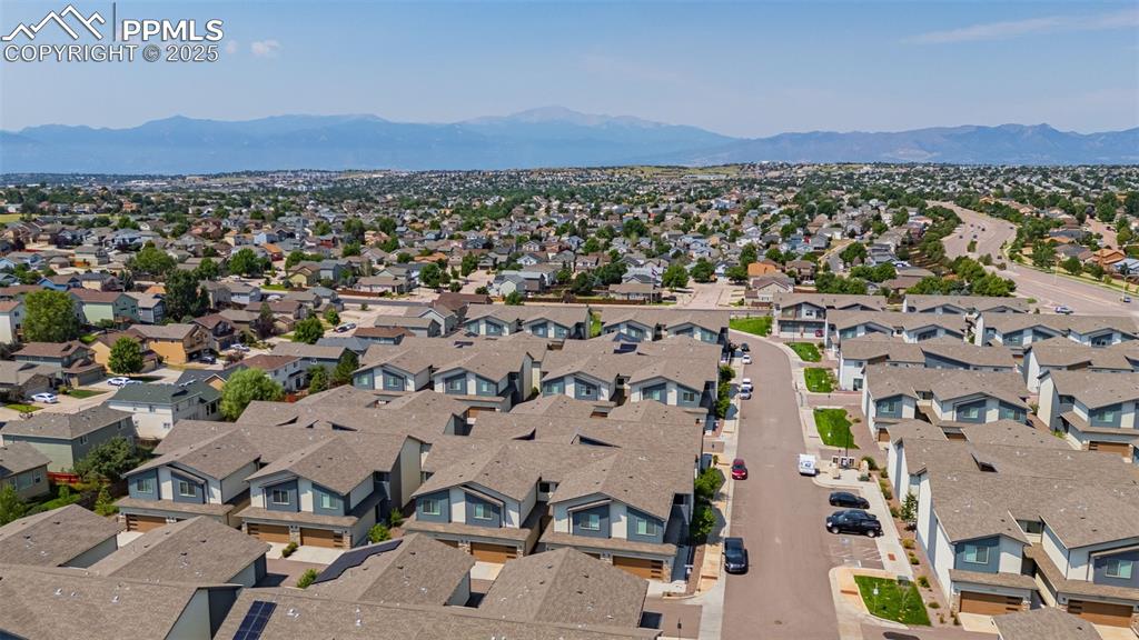 Image 33 of 33: Aerial perspective of suburban area featuring a mountainous background
