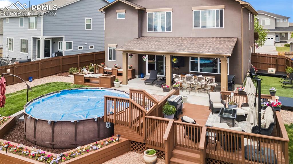 Image 10 of 45: Back of property with outdoor lounge area, a fenced backyard, stucco siding