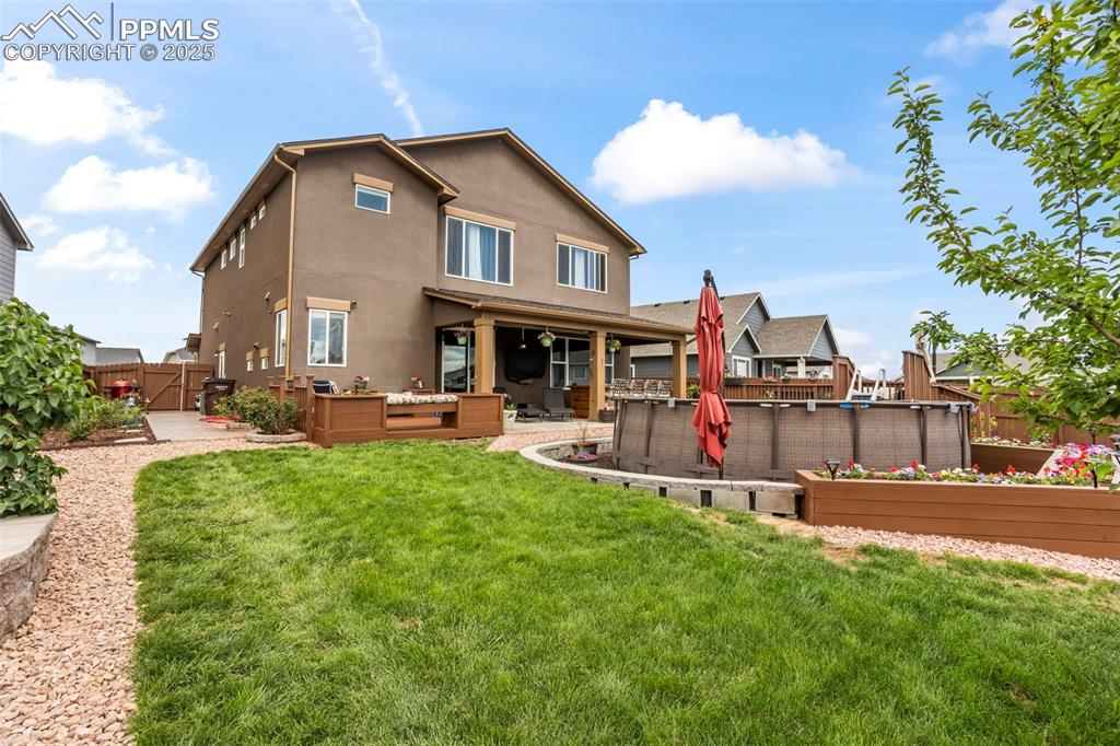 Image 11 of 45: Back of house featuring outdoor lounge area, stucco siding, a patio, and a 