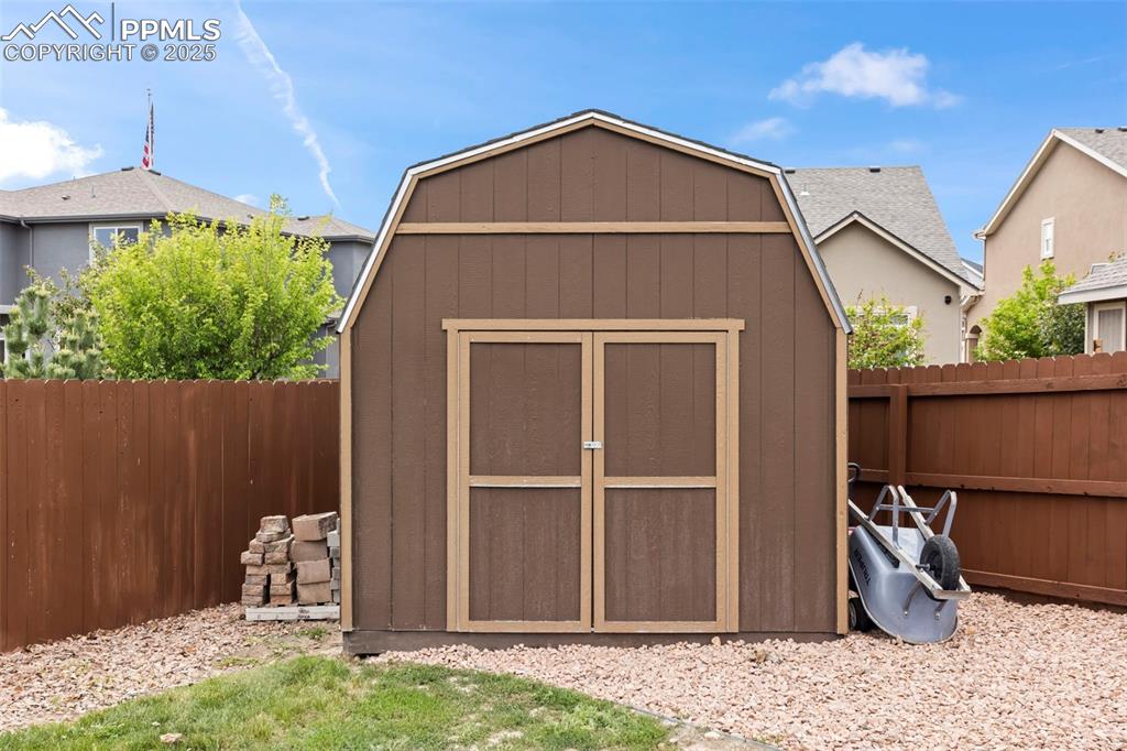 Image 12 of 45: View of shed featuring a fenced backyard