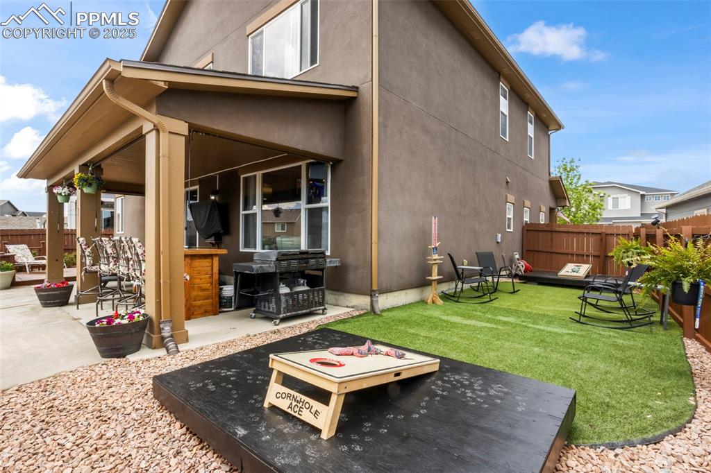 Image 13 of 45: Back of house featuring a patio and stucco siding and Game area,