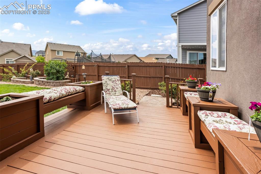 Image 15 of 45: Deck featuring a fenced backyard, a residential view, and 
 garden areas.