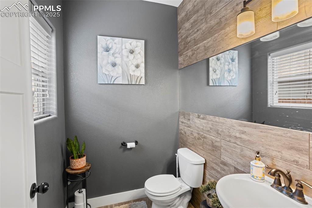 Image 20 of 45: Bathroom with toilet, a sink, and baseboards