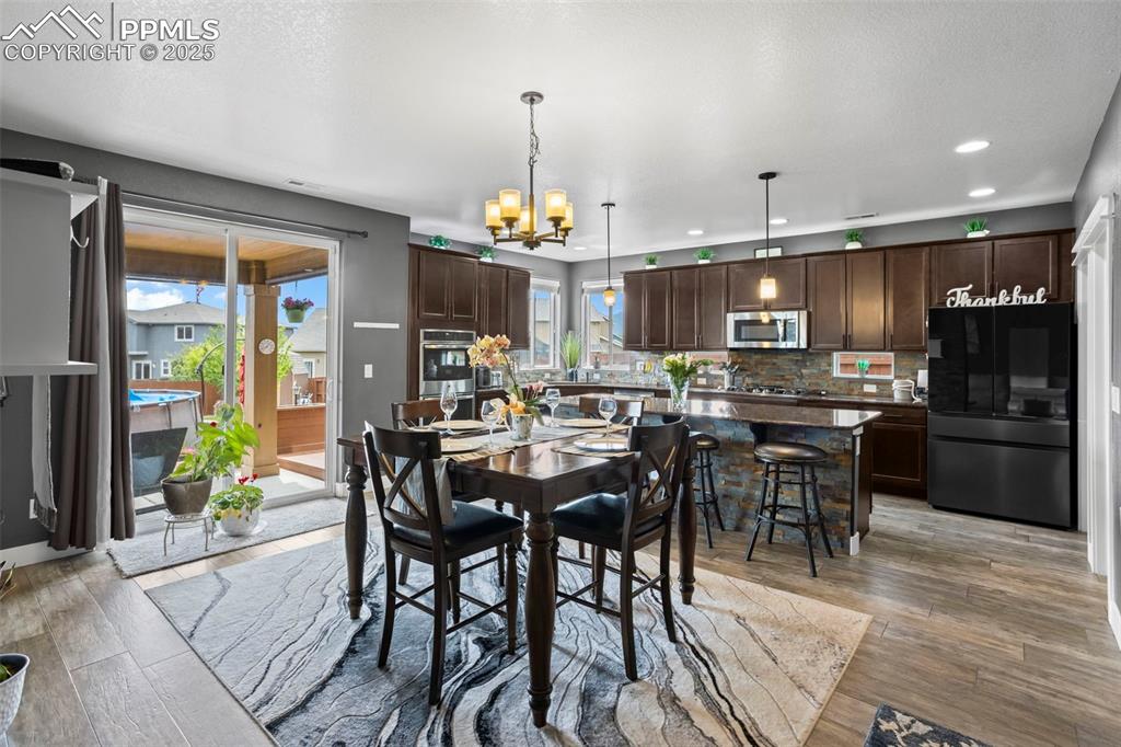 Image 21 of 45: Dining area with plenty of natural light, a chandelier, recessed lighting, 