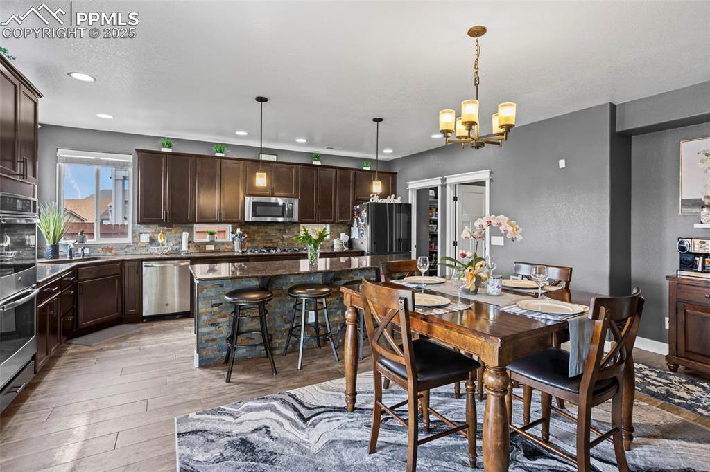 Image 22 of 45: Dining space featuring recessed lighting, light wood finished floors, and a