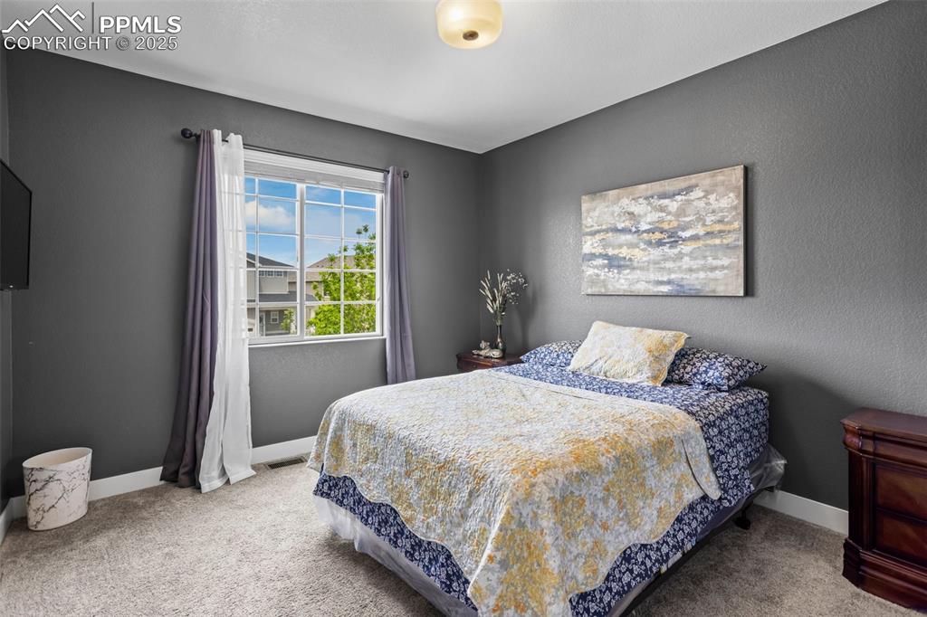 Image 32 of 45: Carpeted bedroom with ceiling fan and custom baseboards