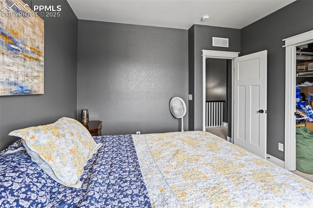Image 33 of 45: Bedroom with a textured wall
