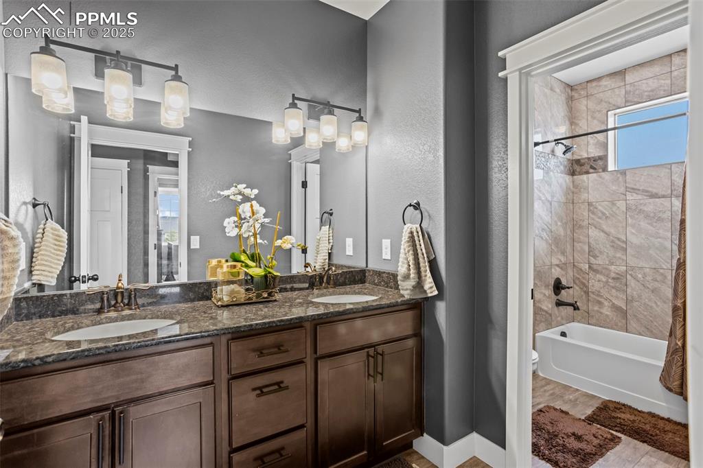 Image 37 of 45: Full bath with double vanity, shower / tub combo, and toilet