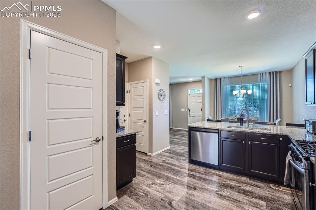 Image 14 of 32: Kitchen featuring appliances with stainless steel finishes, wood finished f