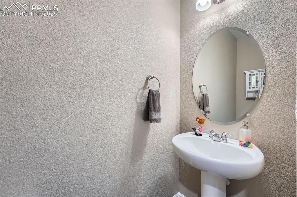 Image 16 of 32: 1/2 Bathroom featuring a textured wall