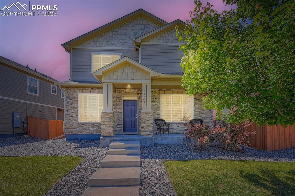 Image 5 of 32: Craftsman inspired home with covered porch and stone siding