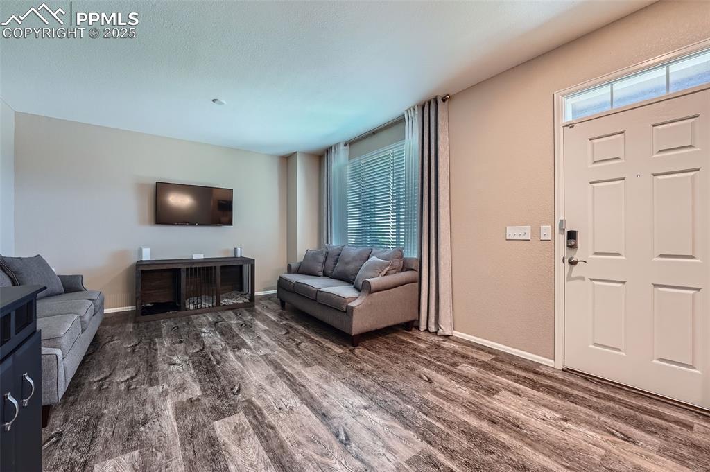 Image 7 of 32: Living area with wood finished floors