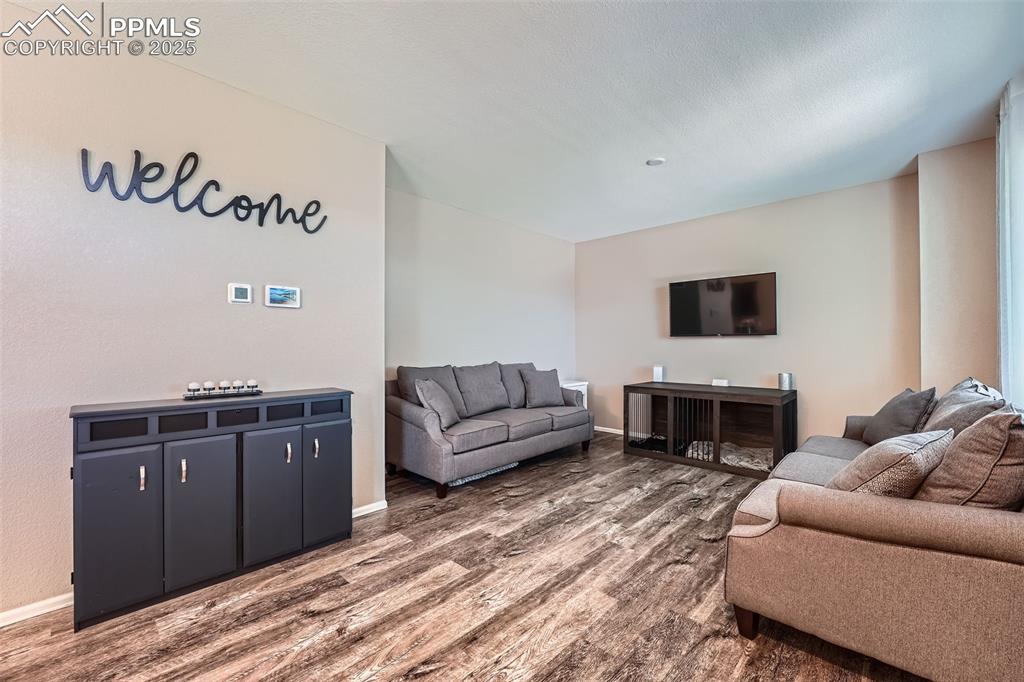 Image 8 of 32: Living area with wood finished floors and baseboards