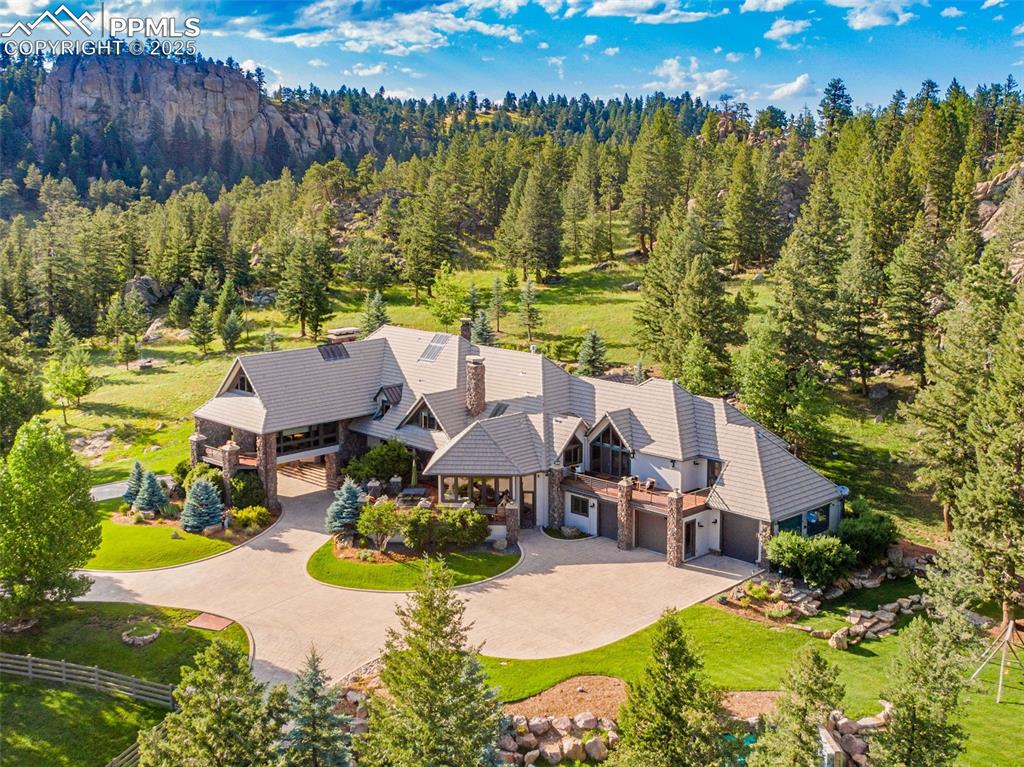 Caption: The home is found at the end of a private and gated drive, surrounded by nature and wildlife