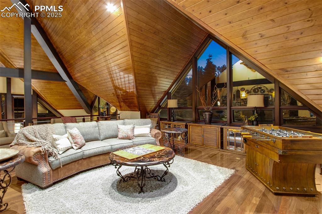 Image 25 of 38: Sitting area/loft above the main floor. Triangular shapes and exotic materi