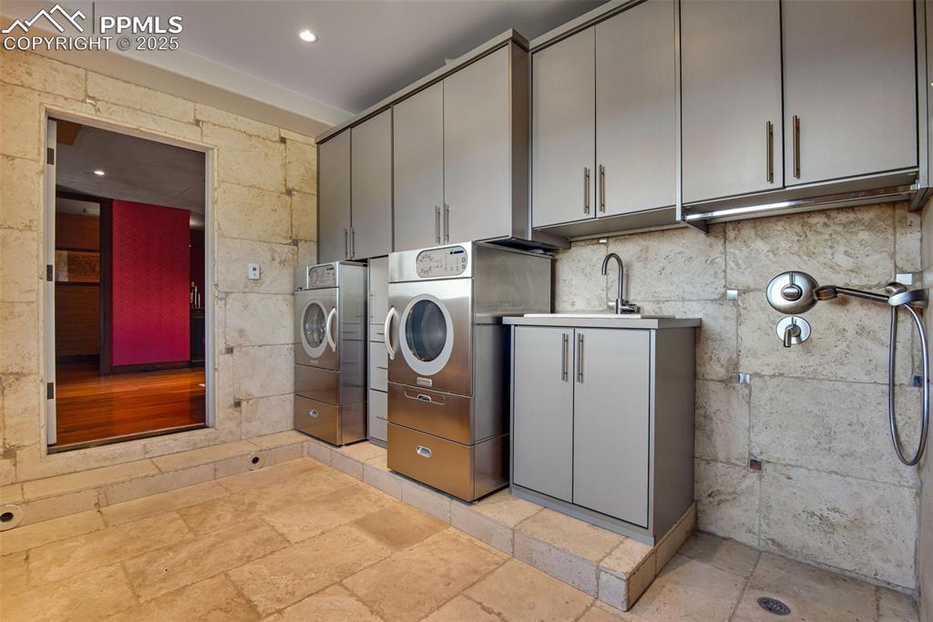 Image 30 of 38: Another laundry area with a doggy wash center is connected to the 4-car tan