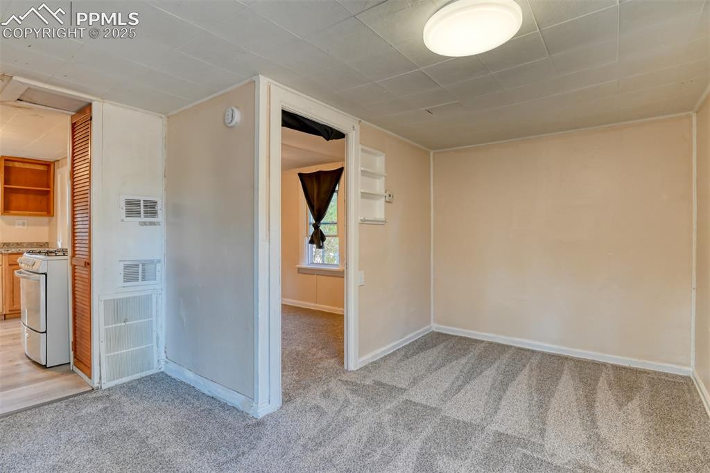 Image 24 of 30: Cottage living room with access to bedroom and kitchen