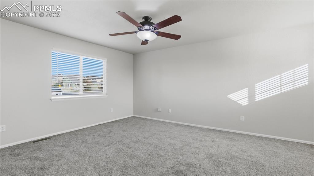 Image 19 of 45: The Primary Bedroom offers new carpet, a lighted ceiling fan, walk in close