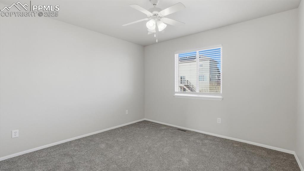 Image 24 of 45: Upper Level Bedroom #2 has new carpet and a lighted ceiling fan.