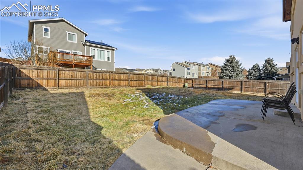Image 41 of 45: Fenced backyard and concrete patio.
