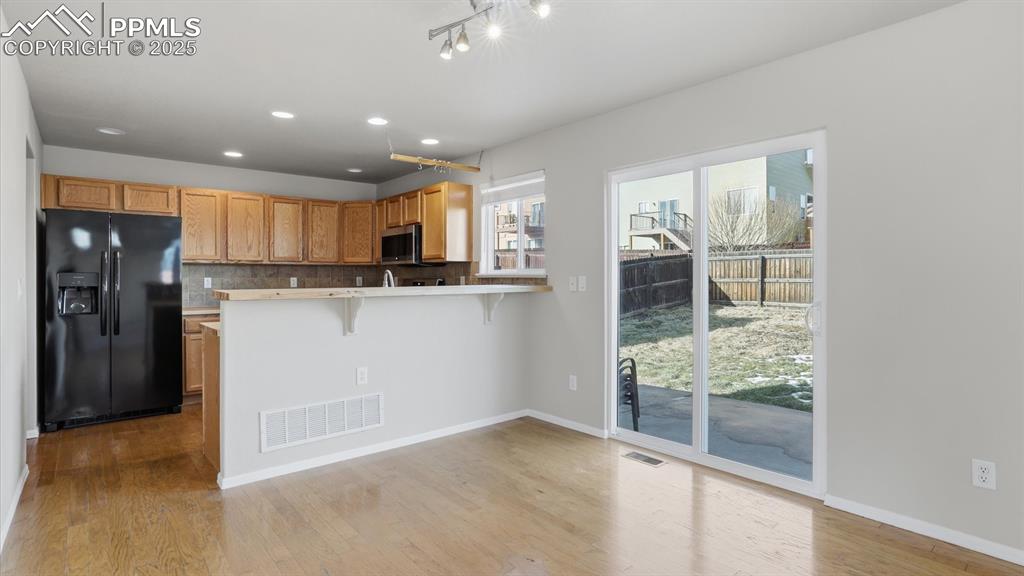 Image 9 of 45: Kitchen/Dining Area with slider to the backyard patio.