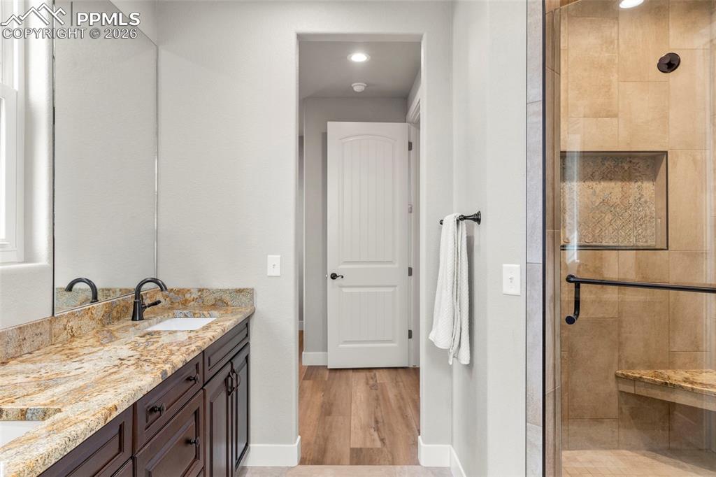 Image 20 of 50: Primary bathrooms feature shower benches and tile niches