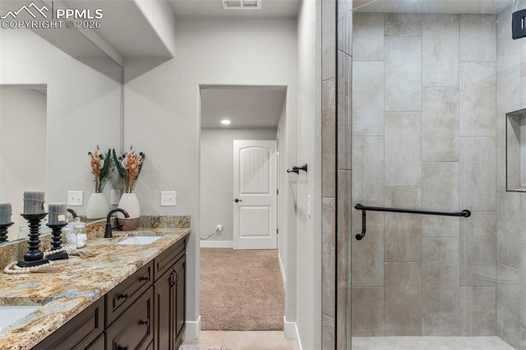Image 31 of 50: Tile shower with bench and glass door