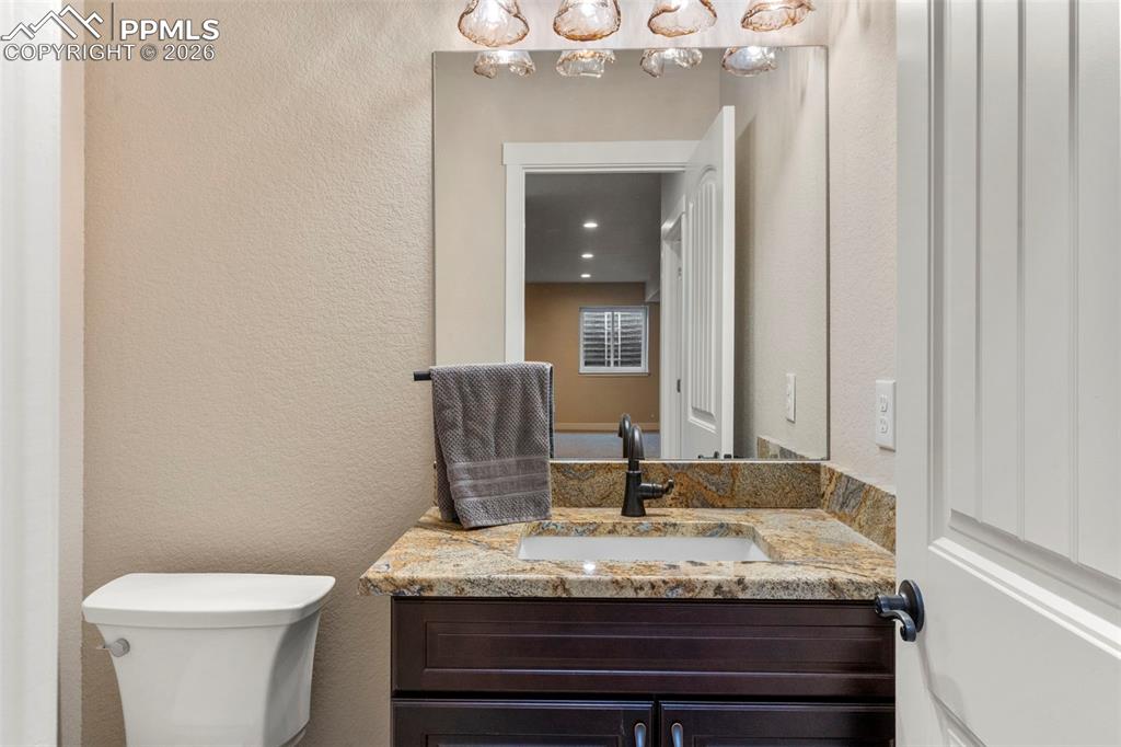 Image 32 of 50: Basement hallway half-bath