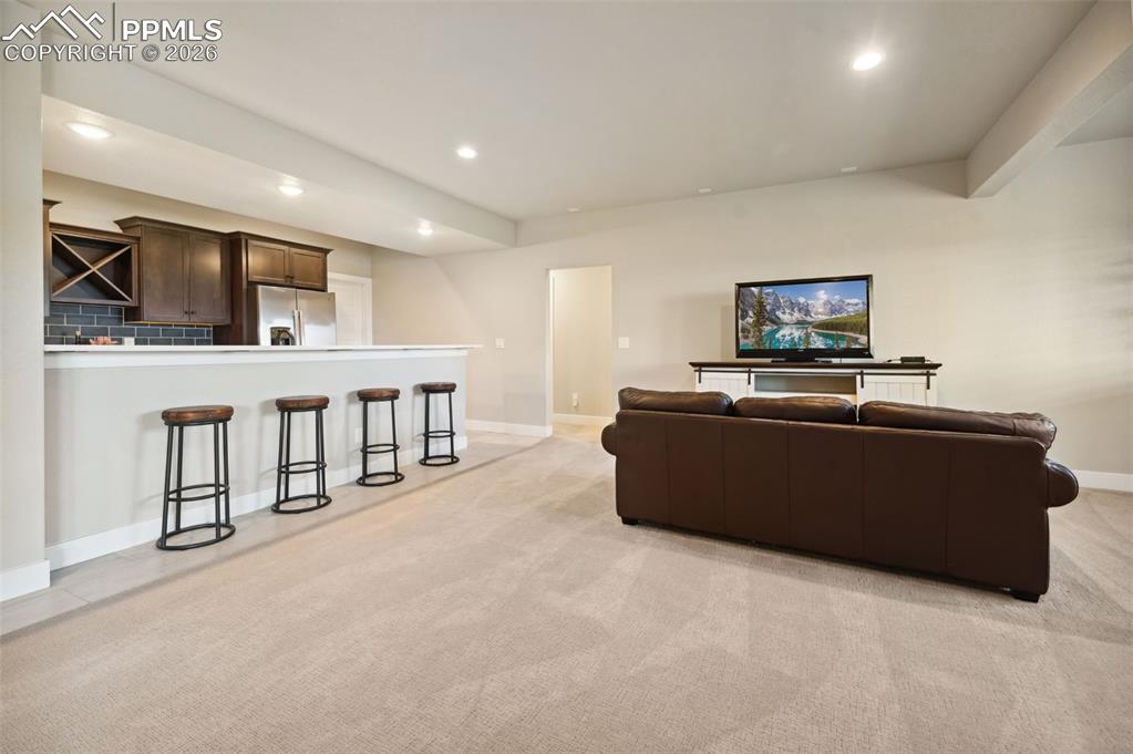 Image 22 of 43: Large lower level family room with kitchenette