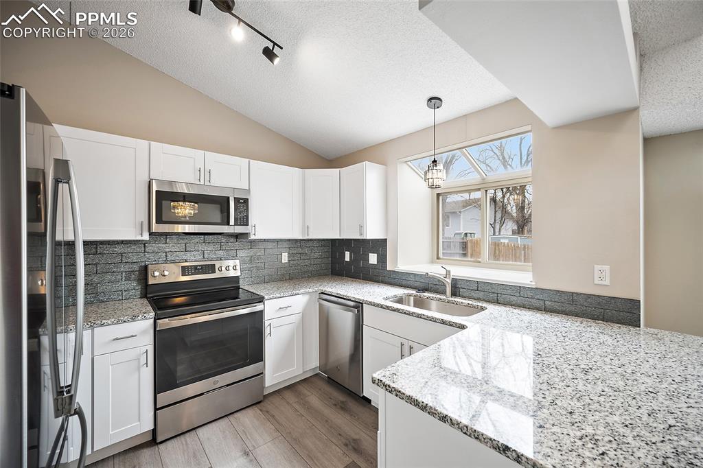 Image 10 of 38: Granite countertops and gorgeous backsplash!
