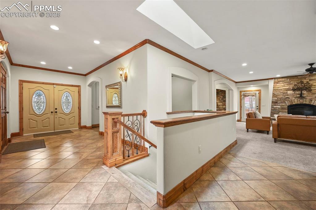 Image 21 of 43: Entry and staircase to lower level