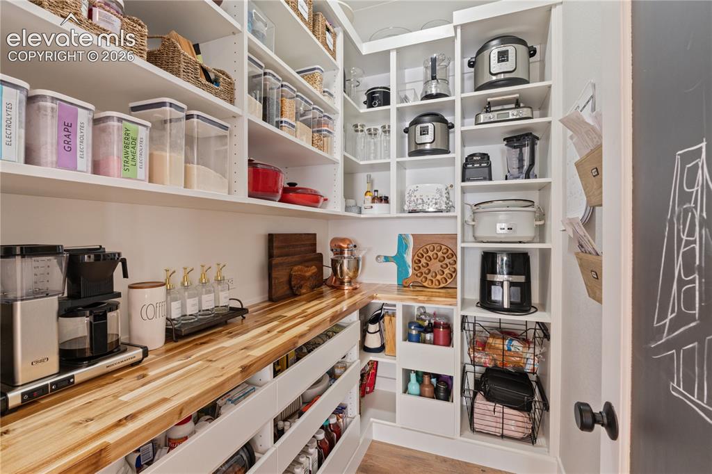 Image 15 of 45: Every closet has custom inserts and cabinetry.
This custom pantry is a mus