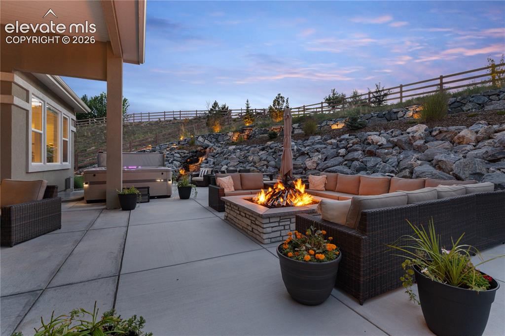 Image 2 of 45: Expansive back patio, HUGE custon waterfall,
custom fire pit, and multiple