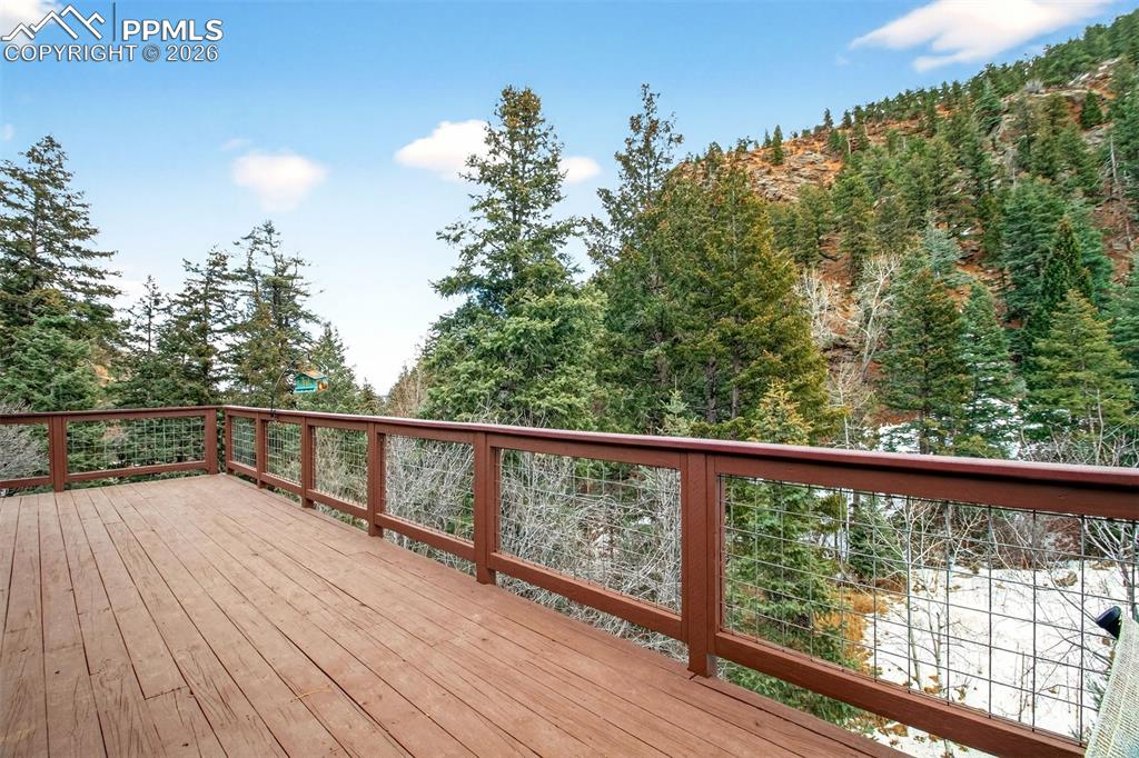 Image 12 of 43: Walk out wrap around deck. Views, Views and more Views!!!