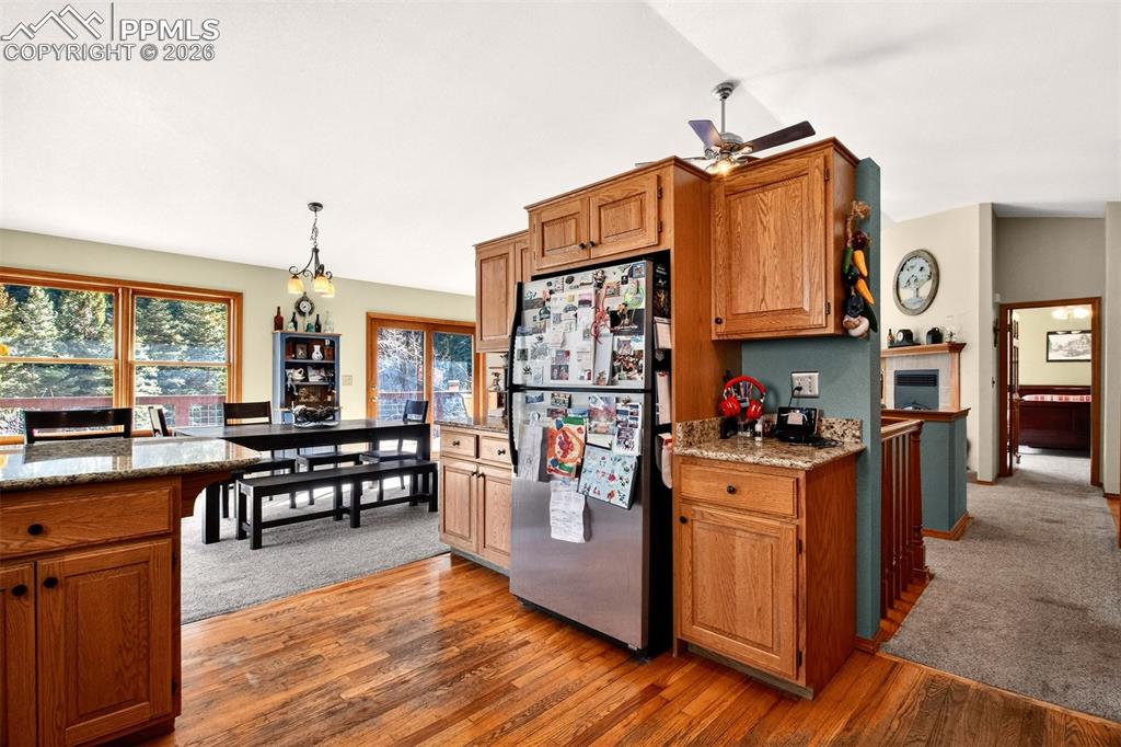 Image 14 of 43: Open concept kitchen with granite countertops, stainless appliances vaulted