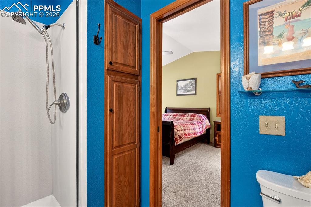 Image 19 of 43: En suite primary bathroom with stand in shower and a skylight