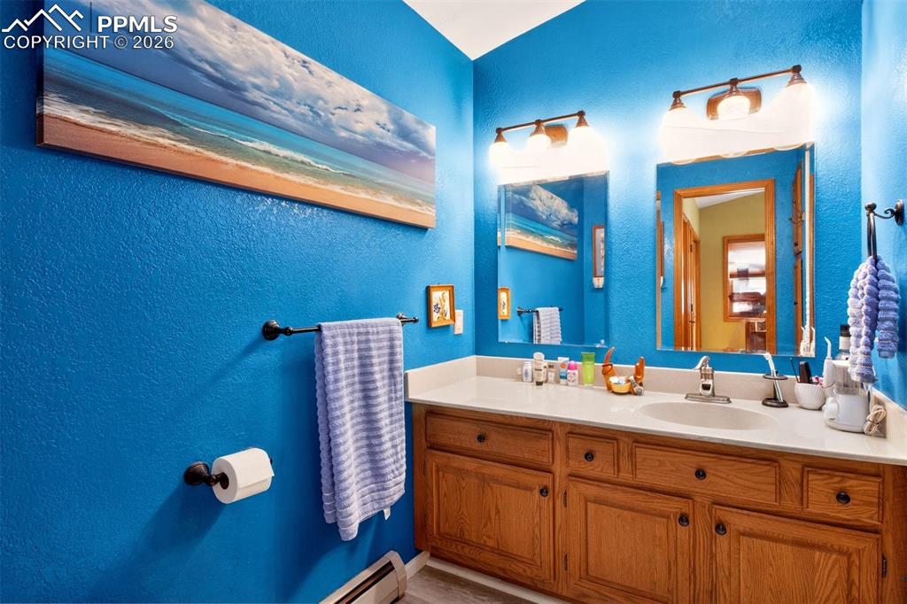 Image 20 of 43: Primary en suite bathroom with stand in shower and a skylight for plenty of