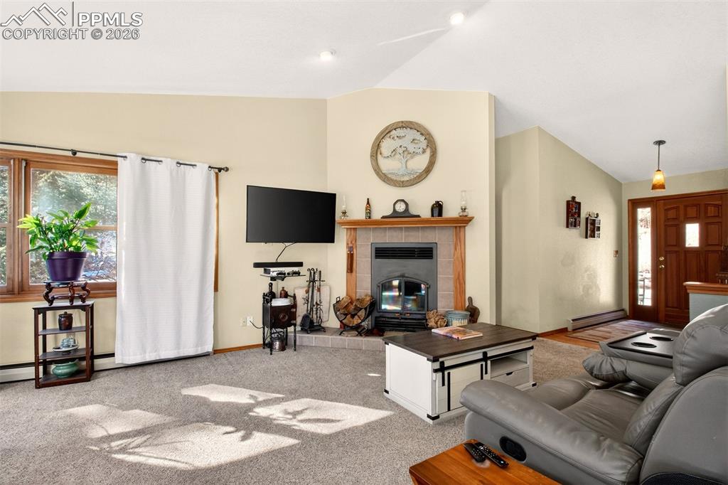 Image 6 of 43: Living room highlighting the wood burning fireplace