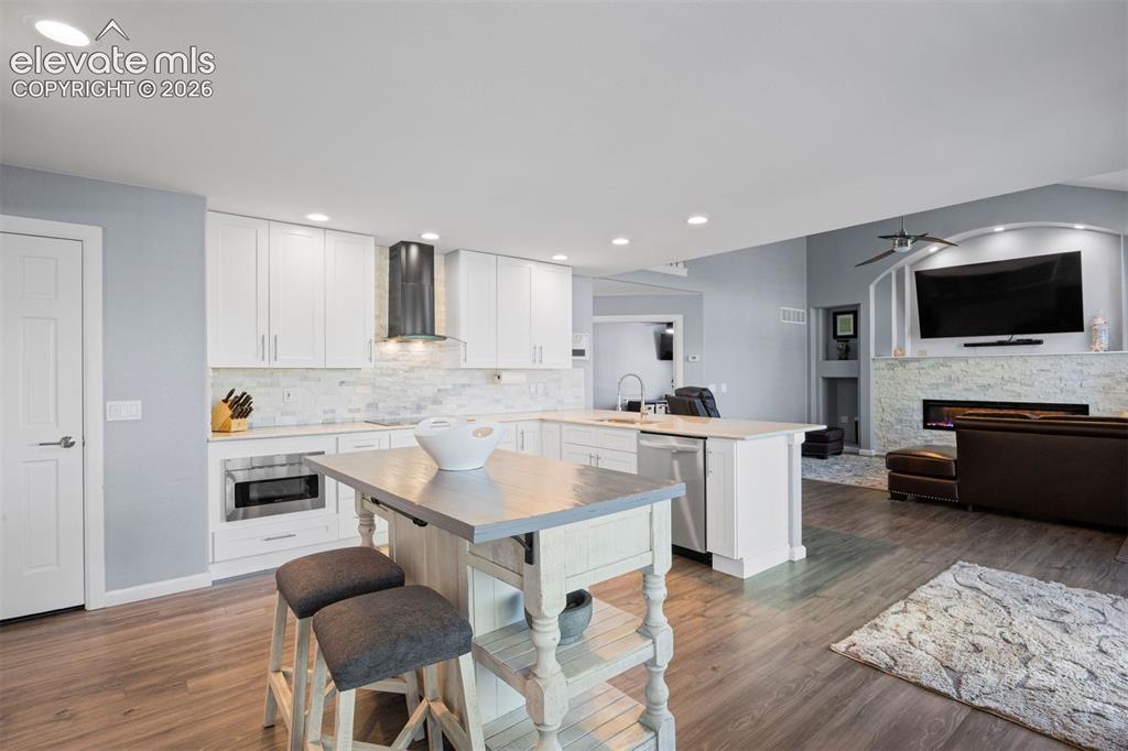 Image 16 of 50: Open-concept living space featuring wood-finish flooring