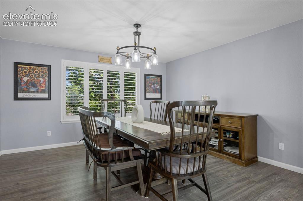 Image 18 of 50: Dining area featuring wood-finish flooring and light gray walls