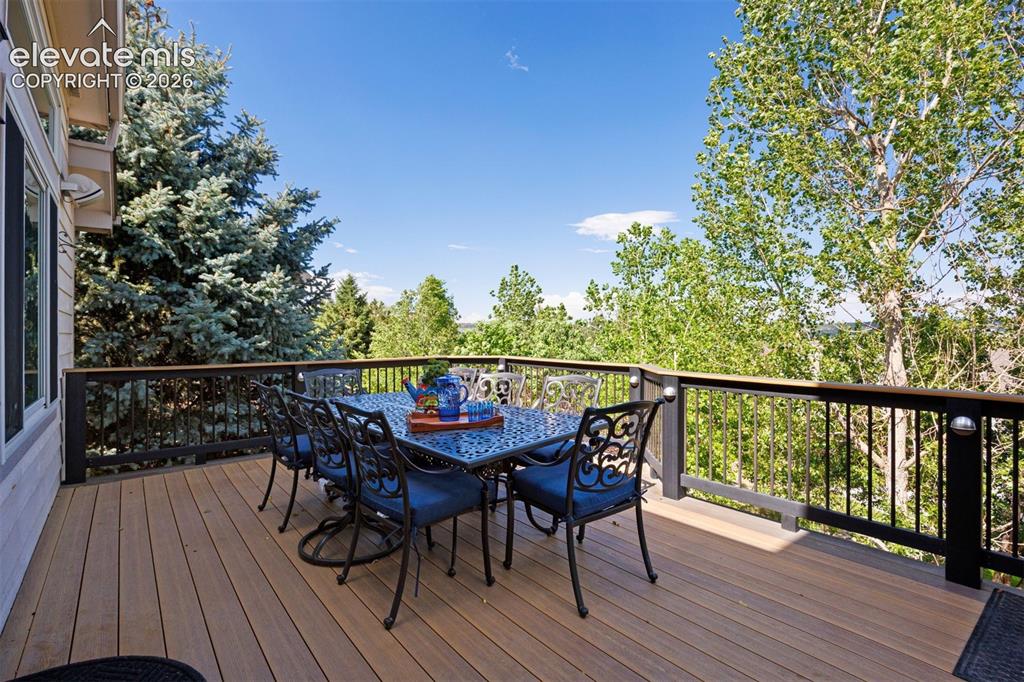 Image 22 of 50: Spacious outdoor deck featuring wood-finish flooring, dark-toned railings w