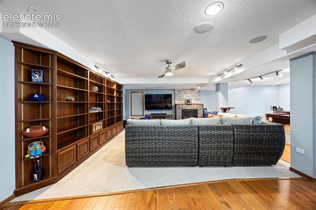 Image 38 of 50: Extensive built-in shelving and cabinetry along one wall