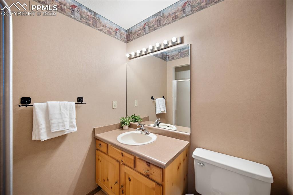Image 17 of 40: Bathroom with vanity and a shower with shower door