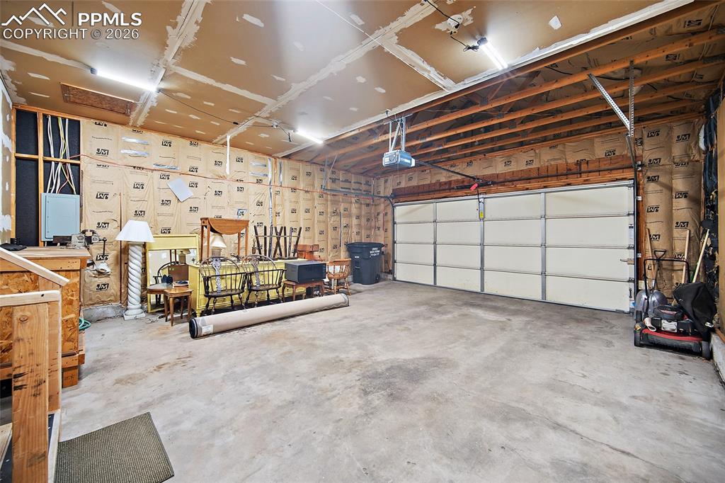 Image 20 of 40: Garage with a garage door opener