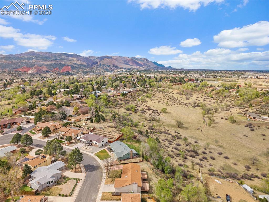 Image 35 of 40: Aerial perspective of suburban area with a mountainous background